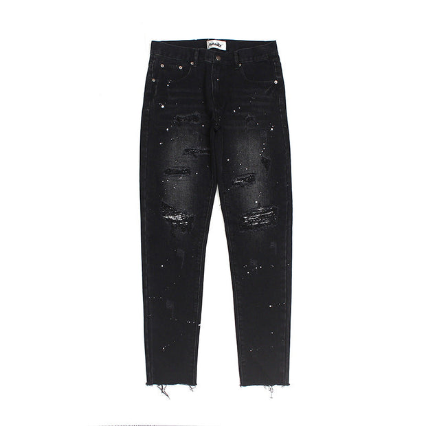 Raw-edge appliquéd cashew flower splattered straight ripped black jeans